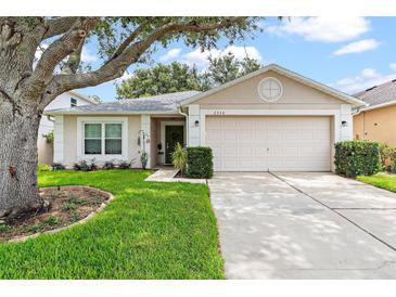 Charming single-story home with a well-maintained lawn and mature tree at 2336 Martins Run, Tavares, FL 32778