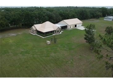 Spacious country home featuring a large lawn and detached garage/workshop at 3147 Rambler Ave, St Cloud, FL 34772