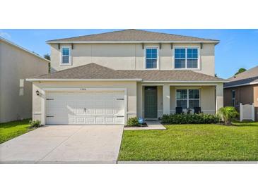 Charming two-story home with a well-maintained lawn and attached two-car garage at 5386 Pine Lilly Dr, St Cloud, FL 34771