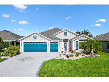 Charming single-story home with a three-car garage and well-manicured lawn and attractive landscaping at 5746 Botner Dr, The Villages, FL 32163