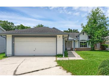 Charming single-story home with a two-car garage, well-maintained lawn, and inviting front entrance at 6556 Piccadilly Ln, Orlando, FL 32835