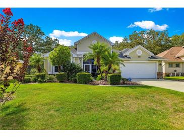 Charming single-Gathering home boasts a well-manicured lawn and tropical landscaping at 8045 Waterbury Way, Mount Dora, FL 32757