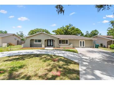 Charming single-story home featuring a well-manicured front lawn and a freshly poured concrete driveway at 910 Rangeline Rd, Longwood, FL 32750