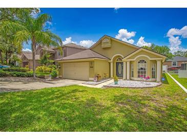 Charming single-Gathering home with well-manicured lawn, inviting curb appeal, and a two-car garage in a sunny setting at 1906 Chathamoor Dr, Orlando, FL 32835