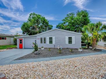 Charming single-story home with a well-maintained yard and attractive landscaping at 25007 Bellevue, Leesburg, FL 34748