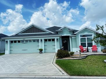 Charming single-story home with two-car garage, manicured lawn, and welcoming front porch area at 2648 Maymont Ct, The Villages, FL 32163
