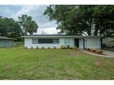 Charming single-story home featuring a well-maintained lawn and freshly painted exterior with dark trim at 2961 Northland Rd, Mount Dora, FL 32757
