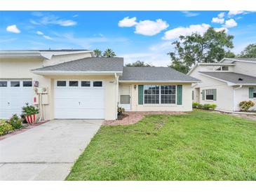 Charming single-story home with a well-maintained front lawn, attached garage, and inviting curb appeal at 1467 Disston Ave, Clermont, FL 34711