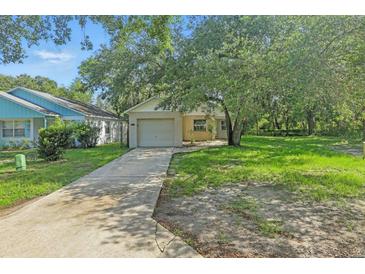 Charming single-story home featuring a front lawn, driveway, and a single-car garage at 2708 Lorraine Dr, Leesburg, FL 34748
