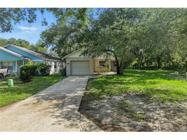 Charming single-Gathering home featuring a well-maintained lawn and mature trees at 2708 Lorraine Dr, Leesburg, FL 34748
