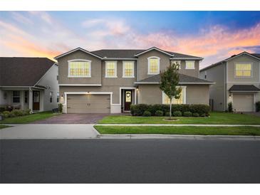 Charming two-story home boasts a well-manicured lawn and a welcoming front entrance at 3304 Canna Lily Pl, Clermont, FL 34711