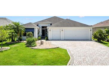 Charming single-story home with a well-manicured lawn and a spacious two-car garage at 3759 Orient Ave, The Villages, FL 32163