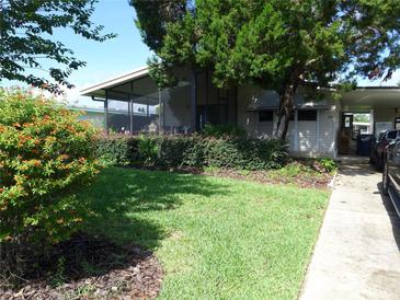 Charming home featuring a well-kept lawn and attractive landscaping at 432 Santa Fe E Rd, Tavares, FL 32778
