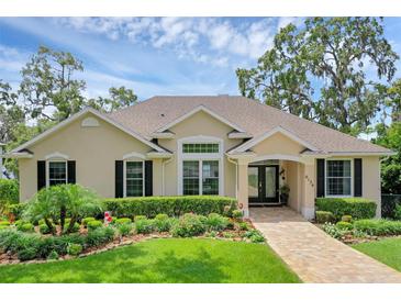 Charming single-story home featuring a well-manicured front yard and inviting entryway at 6136 Lake Emma Rd, Groveland, FL 34736