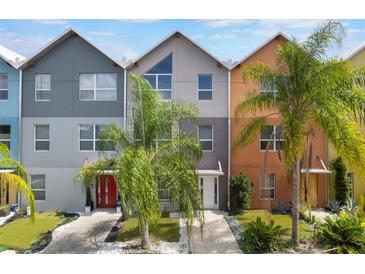 Charming multi-colored townhomes featuring modern architecture and lush palm trees at 1603 Woodward St # 18, Orlando, FL 32803