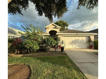 Charming single-story home with a manicured lawn and a two car garage at 15509 Markham Dr, Clermont, FL 34714