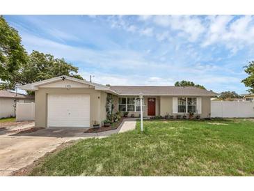 Charming single-story home featuring a well-manicured lawn, a light post and an attached one car garage at 1491 Providence Blvd, Deltona, FL 32725