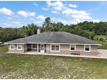 Charming home featuring a spacious backyard, screened porch and classic architecture at 37007 Forestdel Dr, Eustis, FL 32736