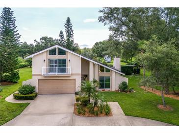 Charming two-story home with a balcony, two-car garage and landscaped yard at 37138 Lake Yale Pl, Grand Island, FL 32735