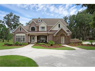 Charming two-story home with landscaped yard and inviting front entrance on a sunny day at 1325 Otters View Ct, Fruitland Park, FL 34731