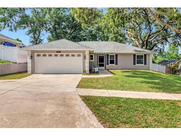 Charming single-story home with a well-manicured lawn and two-car garage at 1511 W Magnolia St, Clermont, FL 34711
