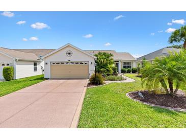 Charming single Gathering home with well manicured landscaping and an attached two car garage at 2017 Palo Alto Ave, The Villages, FL 32159