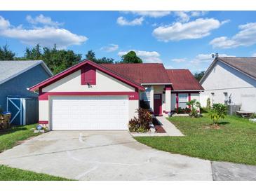 Charming single-story home featuring a well-maintained lawn and attached two-car garage at 3016 Bloomsbury Dr, Kissimmee, FL 34747