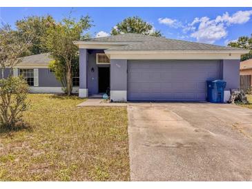 Charming single-story home with a two-car garage and a well-maintained front yard at 428 Coventry Estates Blvd, Deltona, FL 32725
