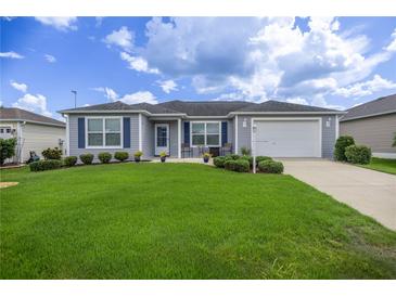 Charming single-story home with well-maintained lawn, tidy landscaping, and inviting curb appeal at 516 Junction Pl, The Villages, FL 32163