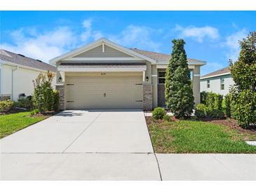 Charming single-Gathering home featuring a well-maintained lawn and a two-car garage at 8128 Penrose Pl, Wildwood, FL 34785