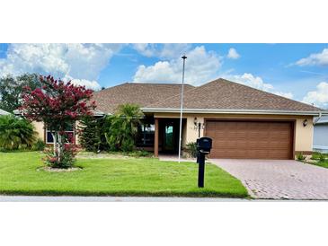 Charming single-story home featuring a well-manicured lawn and mature landscaping at 17329 Se 115Th Ter, Summerfield, FL 34491