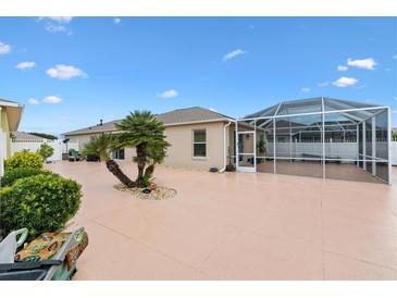 Enclosed patio featuring a concrete pool and palm trees adds an inviting outdoor space at 3105 Carrollton Ct, The Villages, FL 32162