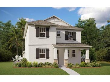 Charming two-story home with a landscaped yard, welcoming entrance and a neutral color palette at 5113 Blanket Flower Way, Apopka, FL 32712