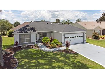 Well-maintained home featuring lovely landscaping and a two-car garage at 670 Fayette Ct, The Villages, FL 32162