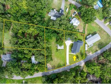 Aerial view of property including adjacent land, driveway, and surrounding mature trees at 16615 Oklahoma St, Clermont, FL 34715
