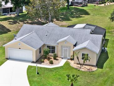 Lovely single-story home featuring manicured landscaping, neutral paint, and a two car garage at 25400 Waterbrook Ct, Leesburg, FL 34748