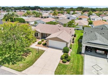 An aerial view of a single-story home featuring well-manicured landscaping and a private driveway at 2746 Edwards Ln, The Villages, FL 32162