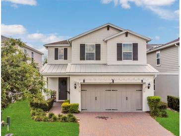 Charming two-story home with a well-manicured lawn and a brick driveway at 2755 Bobcat Chase Blvd, Oakland, FL 34787