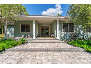 Charming home featuring a stone pathway leading to a covered front porch with classic columns at 32511 County Road 437, Sorrento, FL 32776