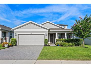 Charming single-story home featuring a manicured front yard, attached two-car garage, and inviting entryway at 3467 Buoy Cir, Winter Garden, FL 34787