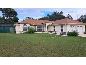 Well-maintained single-story home features a large front yard and an attached two-car garage at 2947 Aldrich St, Eustis, FL 32726