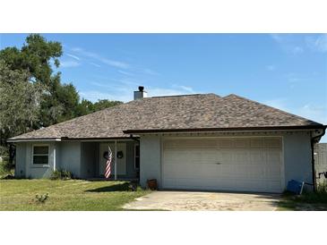Charming single-story home featuring an attached two-car garage and neutral paint at 1801 Ne 77Th St, Ocala, FL 34479