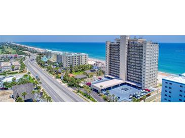 Stunning aerial view of beachfront condo building with ocean views and convenient parking at 89 S Atlantic Ave # 204, Ormond Beach, FL 32176