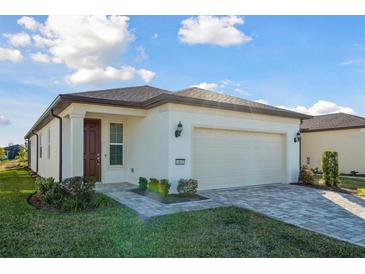 One-story home with a two-car garage and landscaped yard at 6043 Sw 93Rd Cir, Ocala, FL 34481