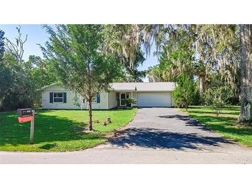 Charming single-story home featuring a well-manicured lawn and an attached two-car garage at 2060 Se 39Th St, Ocala, FL 34480