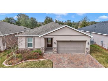 Charming single-story home with well-manicured lawn and brick-paved driveway at 4358 Nw 57Th Ave, Ocala, FL 34482