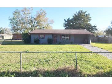 Cozy single-story home featuring a spacious front yard and driveway at 1040 Ne 25Th St, Ocala, FL 34470