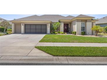 Charming single-story home with a well-maintained lawn and a two car garage at 7274 Sw 95Th Ave, Ocala, FL 34481