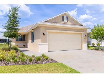 Charming single-story home with a neutral color scheme, well-manicured landscaping, and an attached two-car garage at 8925 Sw 76Th St, Ocala, FL 34481