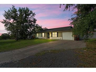 Charming single-story home featuring a well-manicured lawn and a convenient one-car garage at 24 Sapphire Way, Ocala, FL 34472